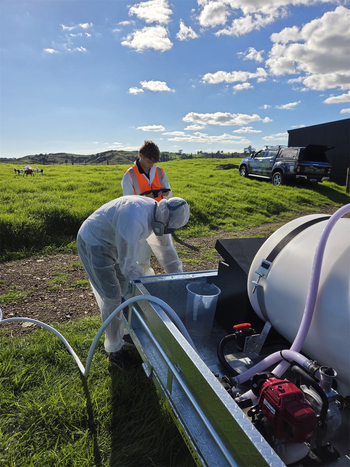 Pilot in PPE mixing spray product at the ute